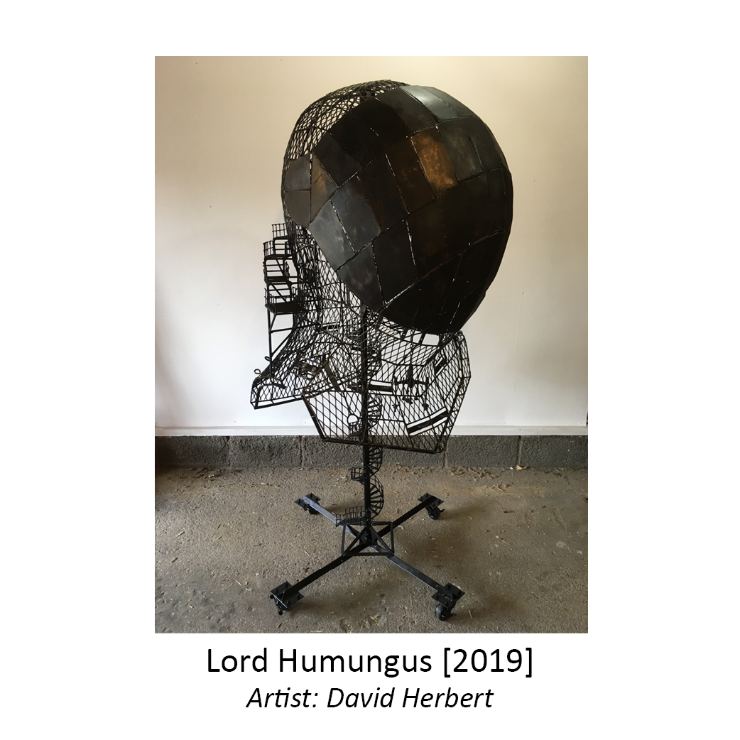 Large black and hollow mesh and metal sculpture of a knight's helmet with staircases and landings inside